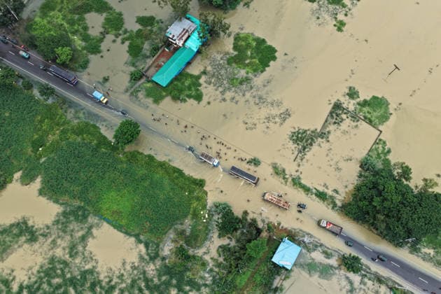 July 11, 2026, Satkania, Chattogram, Bangladesh: July 11, 2026 Ã¢â‚¬ Satkania, Chattogram, Bangladesh: An aerial view shows floodwaters flowing across the Chittagong-CoxÃ¢â‚¬â ¢s Bazar highway as vehicles and people navigate the inundated road. Days of relentless rainfall have caused widespread flooding across Chattogram Division, affecting more than 928,000 people. Satkania Bangladesh - ZUMAh178 20260711_zip_h178_058 Copyright: xMuhammadxAmdadxHossainx