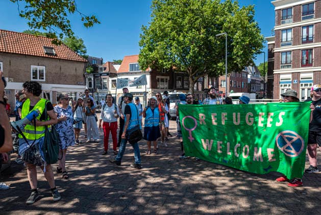 July 11, 2026, Schiedam, South Holland, Netherlands: 11 July 2026. In Schiedam, the Netherlands, a pro-asylum seeker demonstration promoted by Extinction Rebellion countered a demonstration called the Vrouwenmars tegen het AZC (Women s March Against the AZC) promoted by anti-asylum seeker centre groups. Both events took place in the center of Schiedam. Schiedam Netherlands - ZUMAp202 20260711_zip_p202_003 Copyright: xJamesxPetermeierx