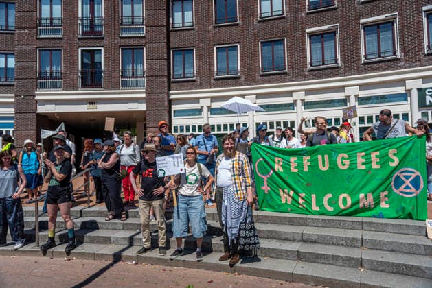 July 11, 2026, Schiedam, South Holland, Netherlands: 11 July 2026. In Schiedam, the Netherlands, a pro-asylum seeker demonstration promoted by Extinction Rebellion countered a demonstration called the Vrouwenmars tegen het AZC (Women s March Against the AZC) promoted by anti-asylum seeker centre groups. Both events took place in the center of Schiedam. Schiedam Netherlands - ZUMAp202 20260711_zip_p202_006 Copyright: xJamesxPetermeierx