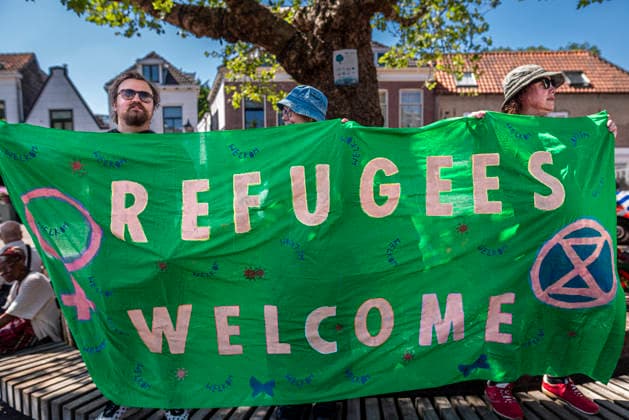July 11, 2026, Schiedam, South Holland, Netherlands: 11 July 2026. In Schiedam, the Netherlands, a pro-asylum seeker demonstration promoted by Extinction Rebellion countered a demonstration called the Vrouwenmars tegen het AZC (Women s March Against the AZC) promoted by anti-asylum seeker centre groups. Both events took place in the center of Schiedam. Schiedam Netherlands - ZUMAp202 20260711_zip_p202_019 Copyright: xJamesxPetermeierx