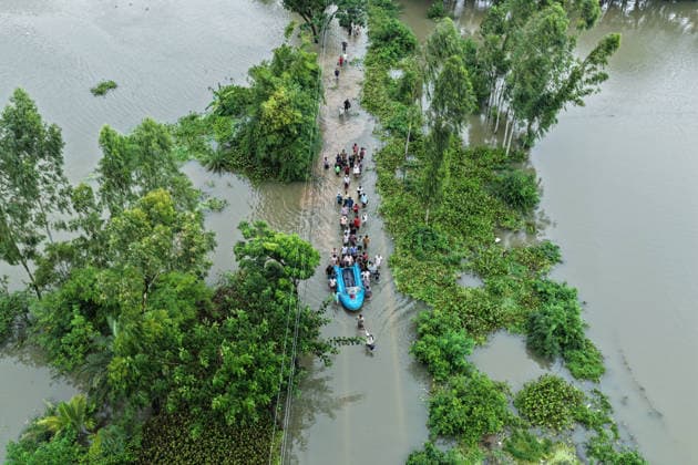 July 10, 2026, Banshkhali, Chattogram, Bangladesh: July 10, 2026 Ã¢â‚¬ Banshkhali, Chattogram, Bangladesh: Villagers wade through floodwaters while transporting the dead body of a boy by boat for burial. Severe flooding has inundated roads and communities across Chattogram Division, killing at least 39 people and affecting more than 928,000. Banshkhali Bangladesh - ZUMAh178 20260710_zip_h178_087 Copyright: xMuhammadxAmdadxHossainx