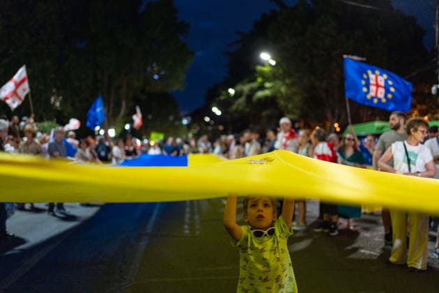 July 11, 2026, Tbilisi, Georgia: Protesters carry a large Ukrainian flag as they mark 591st day of anti-government rally in Tbilisi, Georgia. Tbilisi Georgia - ZUMAz174 20260711_zip_z174_008 Copyright: xMoexZoyarix