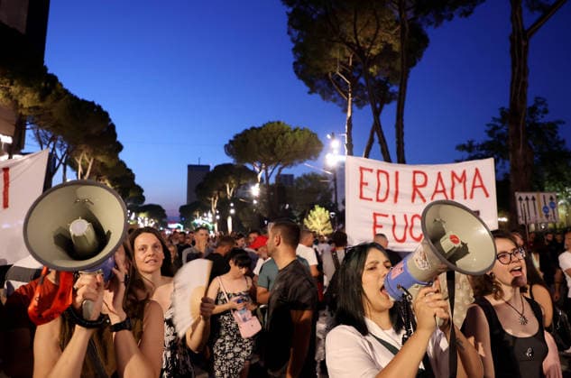 July 11, 2026, Tirane, Albania, ALB: Protesters hold signs and Albanian national flags as they take part in a demonstration in front of the PM office in Tirana on July 11, 2026, opposing the construction of a luxury resort in a protected natural area near the city of Vlore. Several thousand citizens demonstrated in Tirana for the 42nd consecutive night to demand transparency on a luxury tourism complex project in the protected area of Narta Lagoon in the city of Vlore linked to US President Donald Trump s son-in-law, Jared Kushner, and his wife, Ivanka Trump. The project was planned for two areas along the Adriatic coast: the protected delta area of Vjosa-Narta and the nearby uninhabited island of Sazan. Tirane ALB  - ZUMAs337 20260711_znp_s337_021 Copyright: xGentxShkullakux