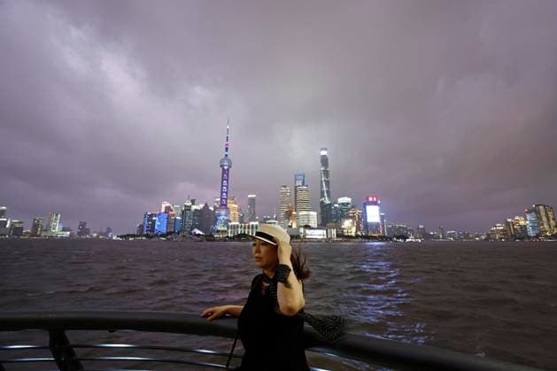 SHANGHAI, CHINA - JULY 11: A tourist poses for a photo on the Bund as Typhoon Bavi approaches on July 11, 2026 in Shanghai, China. Typhoon Bavi, the ninth typhoon of the year, is expected to make landfall along the coast between Wenling and Rui an in east China s Zhejiang Province from the night of July 11 to early morning of July 12, according to the National Meteorological Center.  Copyright: xChinaxNewsxServicex 111653697395