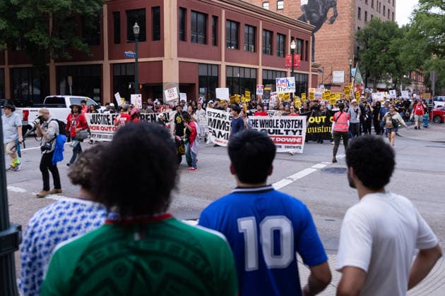 July 11, 2026, Houston, Texas, USA: Bystanders watch protesters march in Downtown Houston to protest against U.S. Immigration and Customs Enforcement (ICE) after Lorenzo Salgado Araujo was fatally shot by an ICE agent during an attempted immigration enforcement operation, an incident that has prompted calls from community leaders and elected officials for an independent investigation, Saturday, July 11, in Houston, Texas. Houston USA  - ZUMAg287 20260711_zsp_g287_022 Copyright: xMatthewxGuzmanx