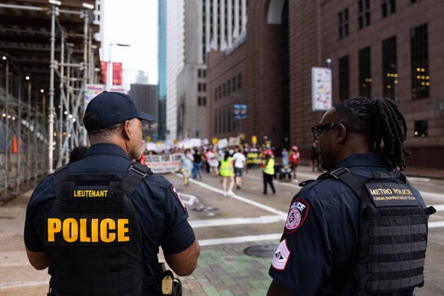 July 11, 2026, Houston, Texas, USA: Houston Police Department officers watch protesters march in Downtown Houston to protest against U.S. Immigration and Customs Enforcement (ICE) after Lorenzo Salgado Araujo was fatally shot by an ICE agent during an attempted immigration enforcement operation, an incident that has prompted calls from community leaders and elected officials for an independent investigation, Saturday, July 11, in Houston, Texas. Houston USA  - ZUMAg287 20260711_zsp_g287_118 Copyright: xMatthewxGuzmanx