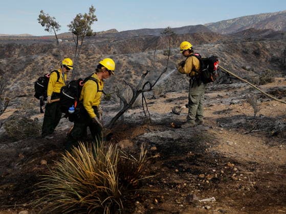 (260712) -- ANTELOPE VALLEY, July 12, 2026 -- Firefighters mop up debris after battling a brush fire in Antelope Valley, Los Angeles County, California, the United States, July 11, 2026. A wildfire burning in U.S. Southern California exploded to nearly 2,700 acres (about 10.9 square kilometers) Saturday, forcing evacuations amid dangerous heat wave. (Photo by Xinhua) U.S.-CALIFORNIA-LOS ANGELES COUNTY-WILDFIRE QiuxChen 
