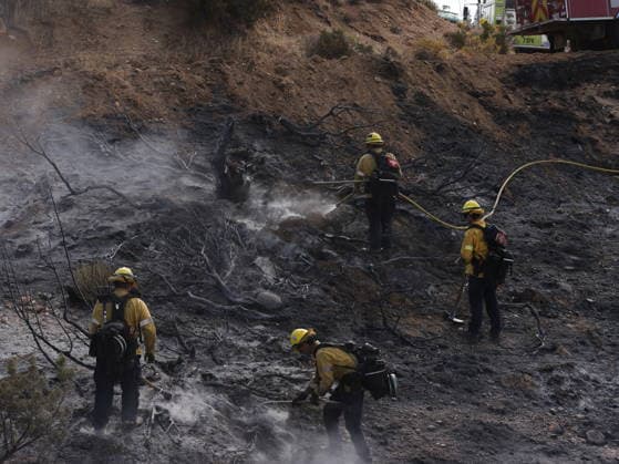 (260712) -- ANTELOPE VALLEY, July 12, 2026 -- Firefighters mop up debris after battling a brush fire in Antelope Valley, Los Angeles County, California, the United States, July 11, 2026. A wildfire burning in U.S. Southern California exploded to nearly 2,700 acres (about 10.9 square kilometers) Saturday, forcing evacuations amid dangerous heat wave. (Photo by Xinhua) U.S.-CALIFORNIA-LOS ANGELES COUNTY-WILDFIRE QiuxChen 