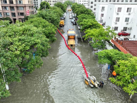 (260712) -- WENZHOU, July 12, 2026 -- An aerial drone photo taken on July 12, 2026 shows staff workers draining floodwaters from an inundated road in Yueqing City, east China s Zhejiang Province. Typhoon Bavi, the ninth typhoon of the year, landed on the coast of east China s Zhejiang Province at around 11:20 p.m. Saturday, according to the Zhejiang provincial meteorological observatory. The typhoon, with the maximum wind force at its center reaching 40 meters per second when landing, first churned ashore at Yuhuan City, a county-level city administered by the city of Taizhou, before making a second landfall in Yueqing City under the city of Wenzhou at around midnight. After landfall, the typhoon is expected to continue moving northwes 