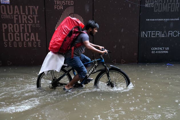 July 12, 2026, Dhaka, Dhaka, Bangladesh: A delivery rider pedals through a waterlogged street to deliver products during heavy monsoon rainfall in Dhaka, Bangladesh. Persistent downpours have inundated large parts of the capital, disrupting daily life and transportation while forcing residents to continue their routines despite widespread flooding. Dhaka Bangladesh  - ZUMAk174 20260712_zip_k174_006 Copyright: xSyedxMahabubulxKaderx