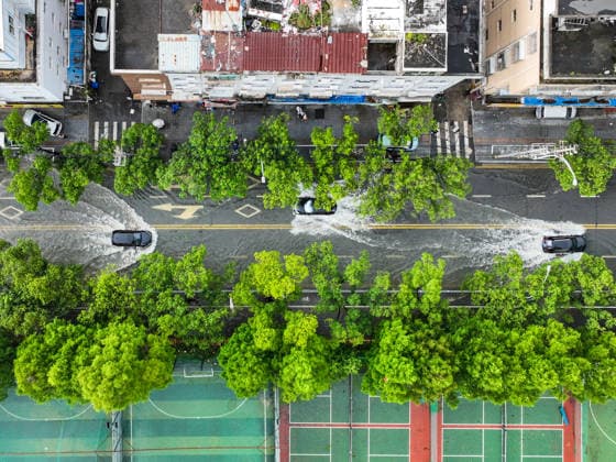 (260712) -- HANGZHOU, July 12, 2026 -- An aerial drone photo taken on July 12, 2026 shows cars moving on an inundated road in Yueqing City, east China s Zhejiang Province. Typhoon Bavi, the ninth typhoon of the year, landed on the coast of east China s Zhejiang Province at around 11:20 p.m. Saturday, according to the Zhejiang provincial meteorological observatory. The typhoon, with the maximum wind force at its center reaching 40 meters per second when landing, first churned ashore at Yuhuan City, a county-level city administered by the city of Taizhou, before making a second landfall in Yueqing City under the city of Wenzhou at around midnight. After landfall, the typhoon is expected to continue moving northwestward while weakening. ) FOC 