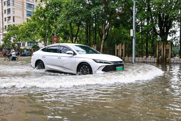 (260712) -- HANGZHOU, July 12, 2026 -- A car moves on an inundated road in Yueqing City, east China s Zhejiang Province, July 12, 2026. Typhoon Bavi, the ninth typhoon of the year, landed on the coast of east China s Zhejiang Province at around 11:20 p.m. Saturday, according to the Zhejiang provincial meteorological observatory. The typhoon, with the maximum wind force at its center reaching 40 meters per second when landing, first churned ashore at Yuhuan City, a county-level city administered by the city of Taizhou, before making a second landfall in Yueqing City under the city of Wenzhou at around midnight. After landfall, the typhoon is expected to continue moving northwestward while weakening. ) FOCUS Typhoon Bavi makes landfall in 