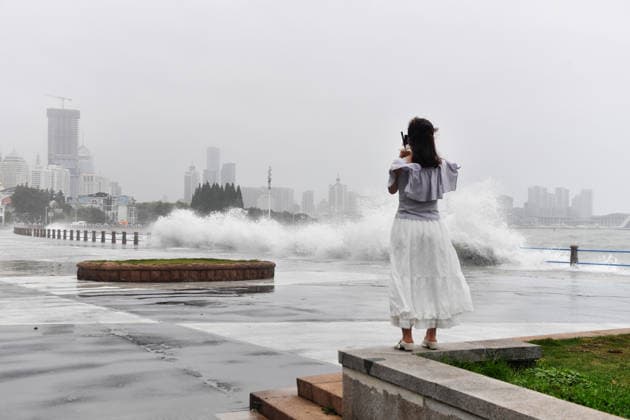 A tourist captures the waves stirred up by Typhoon Bavi on the coast of Aomen Road in Shinan District, Qingdao City, Shandong Province, China on July 12, 2026. Qingdao Shandong China  Copyright: xCFOTOx i1783876252071