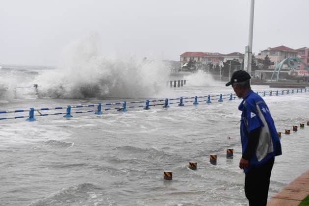 A tourist captures the waves stirred up by Typhoon Bavi on the coast of Aomen Road in Shinan District, Qingdao City, Shandong Province, China on July 12, 2026. Qingdao Shandong China  Copyright: xCFOTOx i1783876255743