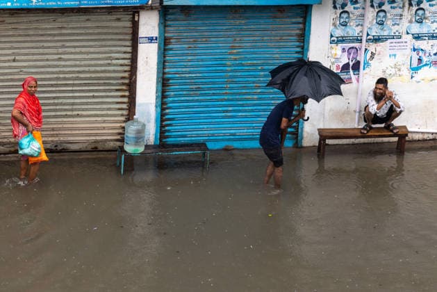 Monsoon downpour made travel slow and dangerous in Dhaka - 12 Jul 2026 People struggle to walk through a waterlogged street following heavy rains causing much suffering for pedestrians and commuters. Monsoon downpour made travel slow and dangerous. Dhaka Bangladesh Copyright: xSazzadxHossainx xSOPAxImagesx Photo_Sazzad Hossain_Monsoon rain (16)