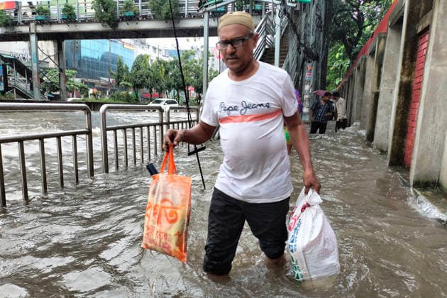 July 12, 2026, Dhaka, Dhaka, Bangladesh: DHAKA, Bangladesh, July 12, 2026 Ã¢â‚¬ Overnight heavy rainfall triggered widespread waterlogging across Dhaka on Sunday, disrupting daily life and causing severe hardship for residents...Several low-lying areas of the capital were submerged under knee- to waist-deep water, forcing commuters, schoolchildren, office workers and daily wage earners to wade through flooded streets. In several neighborhoods, mothers were seen carrying their children, while parents guided students by hand through waterlogged roads...The persistent rainfall caused severe traffic congestion on major roads across the capital, leaving many commuters stranded for hours and delaying travel. According to local residents, inade  - ZUMAk185 20260712_zip_k185_009 Copyright: xRubelxKarmakerx