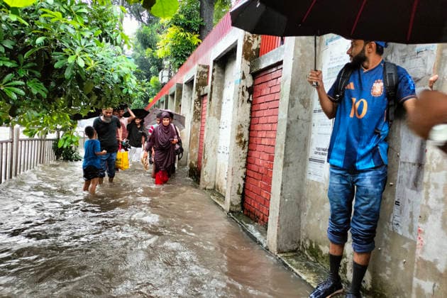 July 12, 2026, Dhaka, Dhaka, Bangladesh: DHAKA, Bangladesh, July 12, 2026 Ã¢â‚¬ Overnight heavy rainfall triggered widespread waterlogging across Dhaka on Sunday, disrupting daily life and causing severe hardship for residents...Several low-lying areas of the capital were submerged under knee- to waist-deep water, forcing commuters, schoolchildren, office workers and daily wage earners to wade through flooded streets. In several neighborhoods, mothers were seen carrying their children, while parents guided students by hand through waterlogged roads...The persistent rainfall caused severe traffic congestion on major roads across the capital, leaving many commuters stranded for hours and delaying travel. According to local residents, inade  - ZUMAk185 20260712_zip_k185_011 Copyright: xRubelxKarmakerx