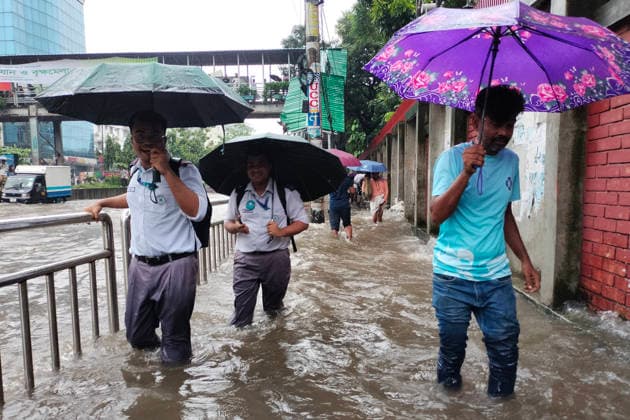 July 12, 2026, Dhaka, Dhaka, Bangladesh: DHAKA, Bangladesh, July 12, 2026 Ã¢â‚¬ Overnight heavy rainfall triggered widespread waterlogging across Dhaka on Sunday, disrupting daily life and causing severe hardship for residents...Several low-lying areas of the capital were submerged under knee- to waist-deep water, forcing commuters, schoolchildren, office workers and daily wage earners to wade through flooded streets. In several neighborhoods, mothers were seen carrying their children, while parents guided students by hand through waterlogged roads...The persistent rainfall caused severe traffic congestion on major roads across the capital, leaving many commuters stranded for hours and delaying travel. According to local residents, inade  - ZUMAk185 20260712_zip_k185_013 Copyright: xRubelxKarmakerx