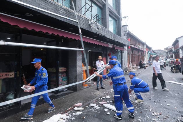 (260712) -- BEIJING, July 12, 2026 -- Emergency workers remove an iron signboard frame blown down by strong winds in Yuhuan of Taizhou City, east China s Zhejiang Province, July 12, 2026. Typhoon Bavi, the ninth typhoon of the year, landed on the coast of east China s Zhejiang Province at around 11:20 p.m. Saturday, according to the Zhejiang provincial meteorological observatory. The typhoon, with the maximum wind force at its center reaching 40 meters per second when landing, first churned ashore at Yuhuan City, a county-level city administered by the city of Taizhou, before making a second landfall in Yueqing City under the city of Wenzhou at around midnight. After landfall, the typhoon is expected to continue moving northwestward 