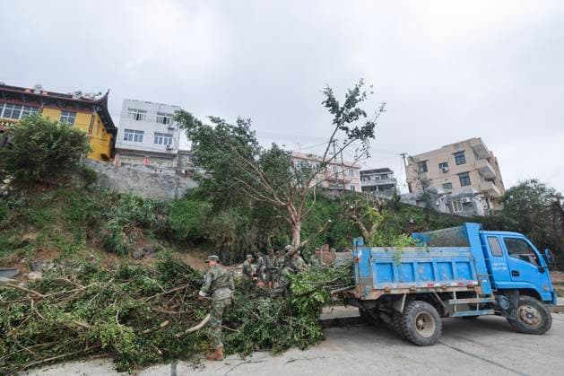 (260712) -- BEIJING, July 12, 2026 -- Soldiers clear branches blown down by strong winds at a community in Yuhuan of Taizhou City, east China s Zhejiang Province, July 12, 2026. Typhoon Bavi, the ninth typhoon of the year, landed on the coast of east China s Zhejiang Province at around 11:20 p.m. Saturday, according to the Zhejiang provincial meteorological observatory. The typhoon, with the maximum wind force at its center reaching 40 meters per second when landing, first churned ashore at Yuhuan City, a county-level city administered by the city of Taizhou, before making a second landfall in Yueqing City under the city of Wenzhou at around midnight. After landfall, the typhoon is expected to continue moving northwestward while weak 