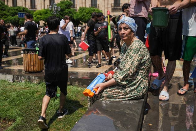 ARMENIA, YEREVAN - JULY 12, 2026: A woman holds a water gun ready as citizens enjoy dousing each other in Republic Square during the traditional feast of Vardavar celebrated by the Armenian Apostolic Church to mark the Transfiguration of Christ Yerevan Armenia  - ZUMAt113 20260712_zaa_t113_150 Copyright: xAlexanderxPatrinx