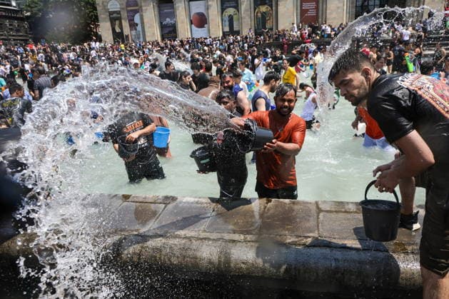 ARMENIA, YEREVAN - JULY 12, 2026: Citizens collect bucketfuls of water from a fountain to douse each other in Republic Square during the traditional feast of Vardavar celebrated by the Armenian Apostolic Church to mark the Transfiguration of Christ Yerevan Armenia  - ZUMAt113 20260712_zaa_t113_160 Copyright: xAlexanderxPatrinx
