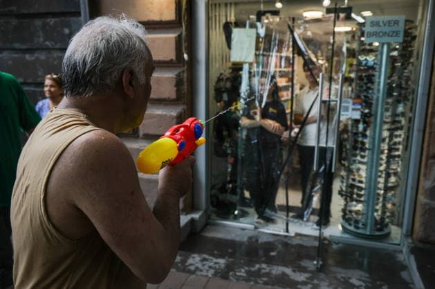 ARMENIA, YEREVAN - JULY 12, 2026: A man shoots his water gun at a shopfront during the traditional feast of Vardavar celebrated by the Armenian Apostolic Church to mark the Transfiguration of Christ Yerevan Armenia  - ZUMAt113 20260712_zaa_t113_178 Copyright: xAlexanderxPatrinx