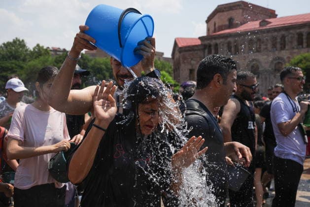 ARMENIA, YEREVAN - JULY 12, 2026: A woman gets doused with a bucketful of water in Republic Square during the traditional feast of Vardavar celebrated by the Armenian Apostolic Church to mark the Transfiguration of Christ Yerevan Armenia  - ZUMAt113 20260712_zaa_t113_258 Copyright: xAlexanderxPatrinx