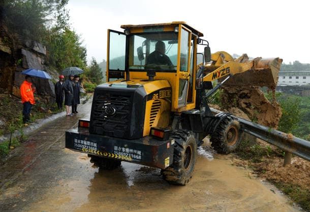 (260712) -- BEIJING, July 12, 2026 -- A staff member drives an excavator to clear a road blocked by small-scale landslides in a village in Qiangtian County, Lishui City, east China s Zhejiang Province, July 12, 2026. Chinese authorities have stepped up flood control and disaster relief efforts as Typhoon Bavi continued to affect large parts of the country on Sunday. Typhoon Bavi, the ninth typhoon of the year, made successive landfalls along the coast of east China s Zhejiang Province late Saturday before moving inland. It is expected to move northwest while gradually weakening. ) CHINA-TYPHOON BAVI-AFTERMATHS (CN) HanxChuanhao 