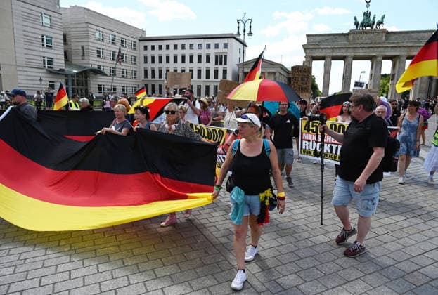A rally in support of a petition for the resignation of Friedrich Merz in Berlin BERLIN, GERMANY - JULY 12: People holding German flags and posters take part in a rally supporting a petition calling for the resignation of German Chancellor Friedrich Merz in front of the Brandenburg Gate in Berlin, Germany, on July 12, 2026. Volodymyr Sindieiev Anadolu Berlin Germany. Editorial use only. Please get in touch for any other usage.  Copyright: x2026xAnadoluxVolodymyrxSindieievx