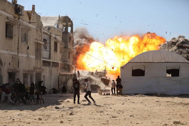 Palestinians seek shelter during Israeli airstrike in Gaza City Palestinians attempt to take cover from a massive explosion following an Israeli airstrike targeting a blacksmith workshop in the al-Sabra neighborhood of Gaza City, on July 12, 2026. Photo by Belal Osama apaimages Gaza Gaza Strip Palestinian Territory 120726_Gaza_BO_3_00(5) Copyright: xapaimagesxBelalxOsamax xapaimagesx