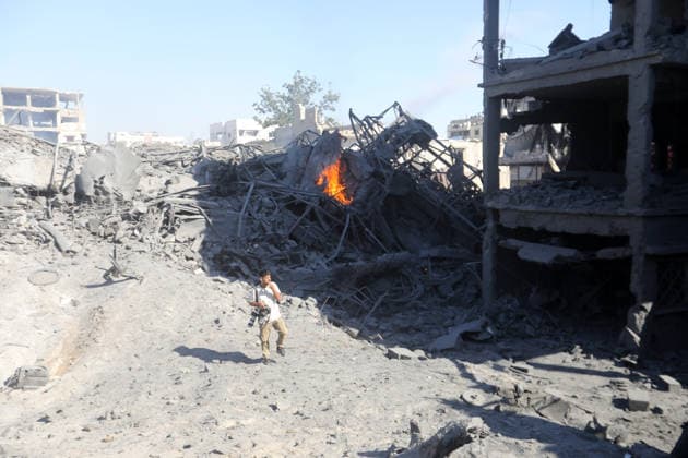 Palestinians inspect damage after Israeli airstrike in Gaza City Palestinians inspect the damage at the site of an Israeli airstrike that targeted a blacksmith workshop in the al-Sabra neighborhood of Gaza City, on July 12, 2026, as Civil Defense firefighters attempts to extinguish a fire that broke out in nearby vehicles and residential buildings following the strike. Photo by Belal Osama apaimages Gaza Gaza Strip Palestinian Territory 120726_Gaza_BO_4_00(11) Copyright: xapaimagesxBelalxOsamax xapaimagesx