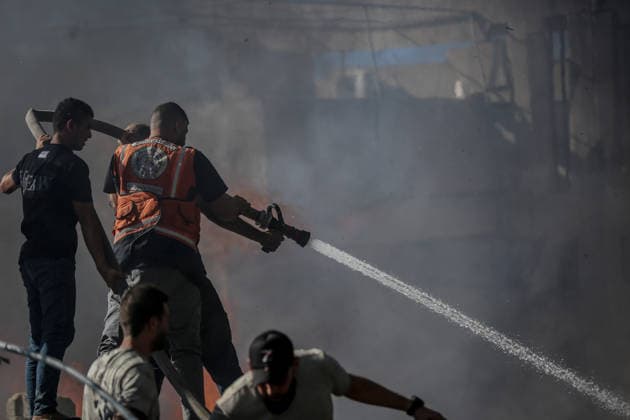 Israeli attacks on Gaza continue in violation of the ceasefire GAZA CITY, GAZA , PALESTINE - JULY 12: Rescuers try to extinguish a fire after the Israeli military targeted several buildings using unmanned aerial vehicles (UAVs) in Al-Sinaa (Industrial) Street in western Gaza City, Palestine on July 12, 2026. The drone-fired missiles caused significant damage and structural ruin across the residential and commercial area. Saeed M. M. T. Jaras Anadolu Gaza City Gaza. Editorial use only. Please get in touch for any other usage.  Copyright: x2026xAnadoluxSaeedxM.xM.xT.xJarasx
