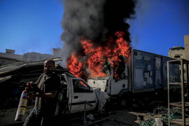 Israeli attacks on Gaza continue in violation of the ceasefire GAZA CITY, GAZA , PALESTINE - JULY 12: Palestinians rush as flame and thick smoke rise from a vehicle and destruction on Al-Sinaa (Industrial) Street in western Gaza City on July 12, 2026, after the Israeli military targeted several buildings using unmanned aerial vehicles (UAVs). The drone-fired missiles caused significant damage and structural ruin across the residential and commercial area. Saeed M. M. T. Jaras Anadolu Gaza City Gaza. Editorial use only. Please get in touch for any other usage.  Copyright: x2026xAnadoluxSaeedxM.xM.xT.xJarasx