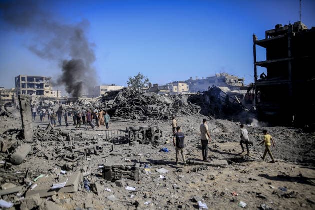 Israeli attacks on Gaza continue in violation of the ceasefire GAZA CITY, GAZA , PALESTINE - JULY 12: Palestinians rush as smoke rises among rubble and destruction on Al-Sinaa (Industrial) Street in western Gaza City on July 12, 2026, after the Israeli military targeted several buildings using unmanned aerial vehicles (UAVs). The drone-fired missiles caused significant damage and structural ruin across the residential and commercial area. Saeed M. M. T. Jaras Anadolu Gaza City Gaza. Editorial use only. Please get in touch for any other usage.  Copyright: x2026xAnadoluxSaeedxM.xM.xT.xJarasx
