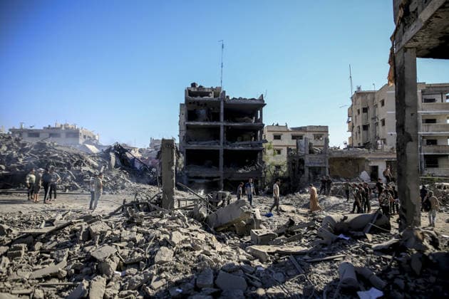 Israeli attacks on Gaza continue in violation of the ceasefire GAZA CITY, GAZA , PALESTINE - JULY 12: Palestinians rush as smoke rises among rubble and destruction on Al-Sinaa (Industrial) Street in western Gaza City on July 12, 2026, after the Israeli military targeted several buildings using unmanned aerial vehicles (UAVs). The drone-fired missiles caused significant damage and structural ruin across the residential and commercial area. Saeed M. M. T. Jaras Anadolu Gaza City Gaza. Editorial use only. Please get in touch for any other usage.  Copyright: x2026xAnadoluxSaeedxM.xM.xT.xJarasx