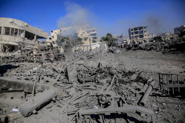 Israeli attacks on Gaza continue in violation of the ceasefire GAZA CITY, GAZA , PALESTINE - JULY 12: Palestinians rush as smoke rises among rubble and destruction on Al-Sinaa (Industrial) Street in western Gaza City on July 12, 2026, after the Israeli military targeted several buildings using unmanned aerial vehicles (UAVs). The drone-fired missiles caused significant damage and structural ruin across the residential and commercial area. Saeed M. M. T. Jaras Anadolu Gaza City Gaza. Editorial use only. Please get in touch for any other usage.  Copyright: x2026xAnadoluxSaeedxM.xM.xT.xJarasx