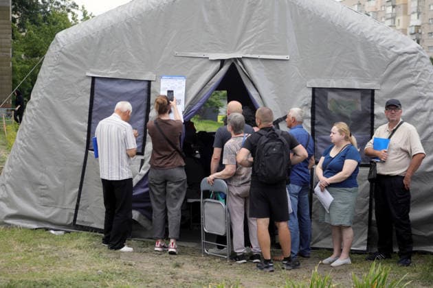 RECORD DATE NOT STATED People affected by a Russian ballistic missile strike wait in line at a mobile tent of the State Emergency Service of Ukraine to receive assistance in the Darnytskyi district of Kyiv, Ukraine, on July 11, 2026. During the night of July 11, Russian forces launched their third ballistic missile attack on Kyiv in a week. Twelve people, including two children aged 10 and 11, were injured (Photo by Yuliia Ovsiannikova Ukrinform) Cleanup underway after Russian attack in Darnytskyi district of Kyiv  Copyright: xYuliiaxOvsiannikovax