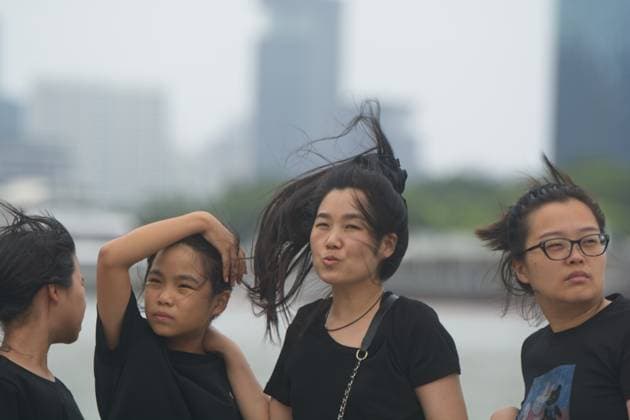 Aftermath Of Super Typhoon Bavi In Shanghai Tourists with their hair blowing in the wind at the Bund in Shanghai, China, on July 12, 2026, as Super Typhoon Bavi makes landfall in Zhejiang province, China. shanghai China  Copyright: xYingxTangx originalFilename: tang-shanghai260712_npbGH.jpg