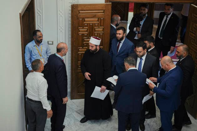 Damascus Syria Parliament First Session Members of Syria s People s Assembly gather inside the parliament building before the first session of the country s new parliament in Damascus, Syria, on July 12, 2026. The 210-member assembly is Syria s first parliament since the fall of the Assad government in December 2024 and is tasked with legislating during the transitional period. Damascus Damascus Syria Copyright: xOmarxAlbamx