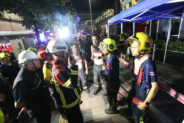 (260713) -- BANGKOK, July 13, 2026 -- Rescuers gather at the scene after a fire broke out at a pub in Bangkok, Thailand, July 13, 2026. A fire at a pub near Lat Phrao Road in Bangkok s Chatuchak district killed 27 people and injured more than 10 others late Sunday, Thai media reported. The fire broke out at around 11:57 p.m. local time and was later extinguished. The injured were taken to hospitals for treatment. ) (SpotNews) THAILAND-BANGKOK-PUB-FIRE RachenxSageamsak 
