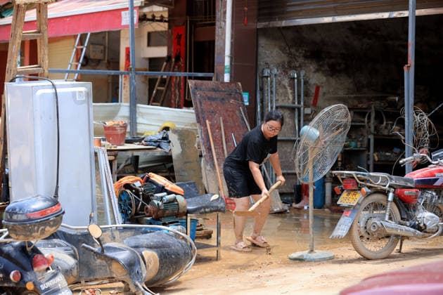 GUIGANG, CHINA - JULY 12: A villager clean furniture soaked by floodwaters on July 12, 2026 in Guigang, Guangxi Zhuang Autonomous Region of China. Floodwaters have receded and residents lives have returned to normal.  Copyright: xVCGx 111653899641