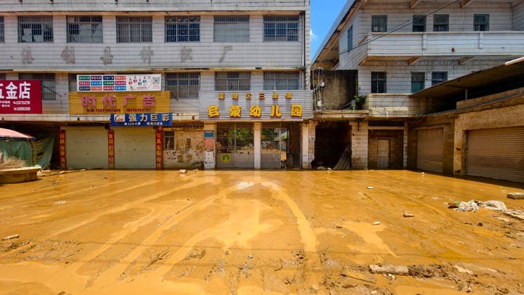 GUIGANG, CHINA - JULY 12: Shops and houses along the street are submerged by floodwaters on July 12, 2026 in Guigang, Guangxi Zhuang Autonomous Region of China. Floodwaters have receded, and mud remains on the road surfaces.  Copyright: xVCGx 111653899650