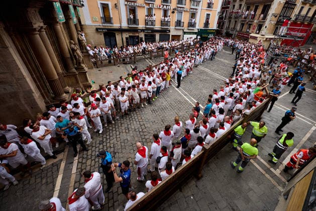 July 13, 2026, Pamplona, Navarre, Spain: People take part in the traditional encierro (bull-run) of the San Fermin Festival in Pamplona, Spain on July 13, 2026. The bull-running fiesta is held annually from 06 to 14 July in commemoration of the city s patron saint. Visitors from all over the world attend the festival. Many of them physically participate in the highlight event - the running of the bulls, or encierro - where they attempt to outrun the animals along a route through the narrow streets of Pamplona s old city. Pamplona Spain - ZUMAa206 20260713_zsp_a206_003 Copyright: xRubenxAlbarranx