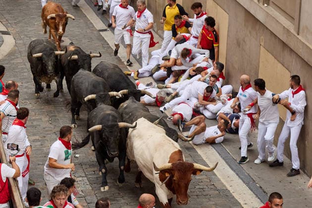 July 13, 2026, Pamplona, Navarre, Spain: People take part in the traditional encierro (bull-run) of the San Fermin Festival in Pamplona, Spain on July 13, 2026. The bull-running fiesta is held annually from 06 to 14 July in commemoration of the city s patron saint. Visitors from all over the world attend the festival. Many of them physically participate in the highlight event - the running of the bulls, or encierro - where they attempt to outrun the animals along a route through the narrow streets of Pamplona s old city. Pamplona Spain - ZUMAa206 20260713_zsp_a206_004 Copyright: xRubenxAlbarranx