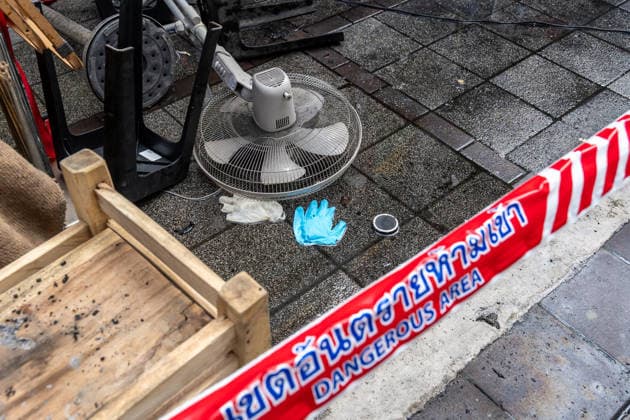 July 13, 2026, Bangkok, Thailand: A view of debris and a blue forensic glove on the ground beneath dangerous area warning tape outside the Rong Beer Na Lat Phrao pub after the fire on Lat Phrao Road in Bangkok. The aftermath of a deadly fire at the Rong Beer Na Lat Phrao pub in Bangkok on 13 July 2026. The blaze killed at least 27 people and injured dozens. Authorities are investigating the cause of the fire. Bangkok Thailand - ZUMAs197 20260713_aaa_s197_003 Copyright: xNathaliexJamoisx