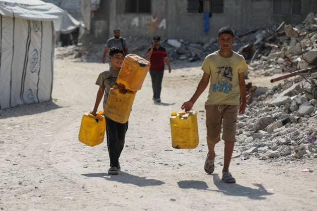 July 13, 2026, Khan Younis, Palestine, State of: KHAN YOUNIS, GAZA STRIP Ã¢â‚¬ JULY 13, 2026: Palestinians wait in line for hours to collect water from a mobile water tanker in central Khan Younis, southern Gaza Strip, on July 13, 2026. With severe shortages of clean water and soaring summer temperatures, residents continue to struggle to secure their daily water supply as the humanitarian crisis deepens. JNA PRESS Khan Younis Palestine, State of - ZUMAq101 20260713_zna_q101_062 Copyright: xRamzixAbuxAmerx
