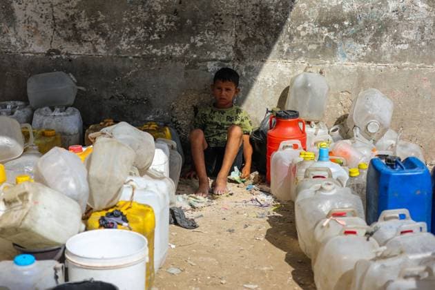 July 13, 2026, Khan Younis, Palestine, State of: KHAN YOUNIS, GAZA STRIP Ã¢â‚¬ JULY 13, 2026: Palestinians wait in line for hours to collect water from a mobile water tanker in central Khan Younis, southern Gaza Strip, on July 13, 2026. With severe shortages of clean water and soaring summer temperatures, residents continue to struggle to secure their daily water supply as the humanitarian crisis deepens. JNA PRESS Khan Younis Palestine, State of - ZUMAq101 20260713_zna_q101_077 Copyright: xRamzixAbuxAmerx