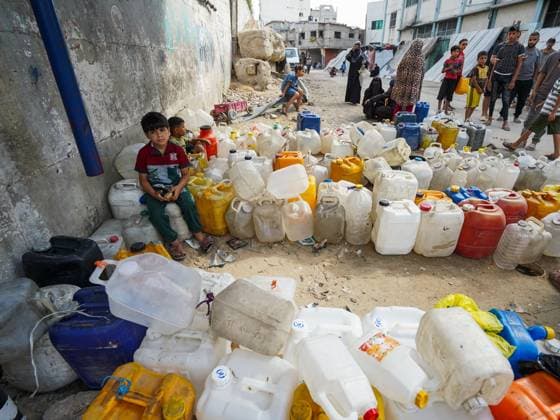 July 13, 2026, Khan Younis, Palestine, State of: KHAN YOUNIS, GAZA STRIP Ã¢â‚¬ JULY 13, 2026: Palestinians wait in line for hours to collect water from a mobile water tanker in central Khan Younis, southern Gaza Strip, on July 13, 2026. With severe shortages of clean water and soaring summer temperatures, residents continue to struggle to secure their daily water supply as the humanitarian crisis deepens. JNA PRESS Khan Younis Palestine, State of - ZUMAq101 20260713_zna_q101_094 Copyright: xRamzixAbuxAmerx