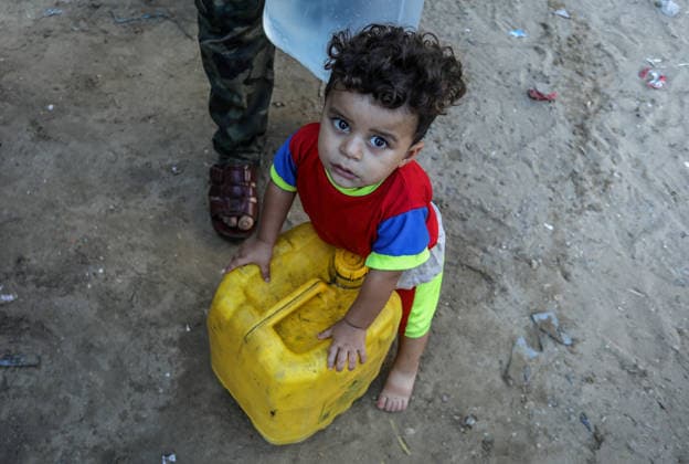 Clean water distribution continues during water crisis in Khan Yunis KHAN YUNIS, GAZA, PALESTINE - JULY 13: A Palestinian child is seen with containers filled with clean water distributed via a supply tanker as water crisis is underway due to severe damage to infrastructure and water wells caused by Israeli attacks in Khan Yunis, Gaza, Palestine on July 13, 2026. Abed Rahim Khatib Anadolu Khan Yunis Gaza. Editorial use only. Please get in touch for any other usage.  Copyright: x2026xAnadoluxAbedxRahimxKhatibx